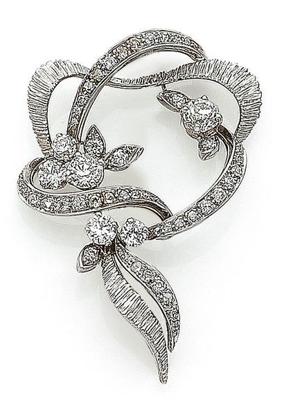 null BRACKET composed of a floral design holding old cut and rose cut diamonds. Mounted...