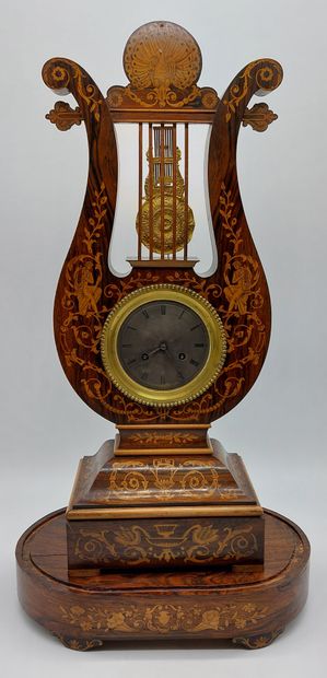 null LYRE CLOCK in mahogany veneer and light wood fillets, the circular movement...