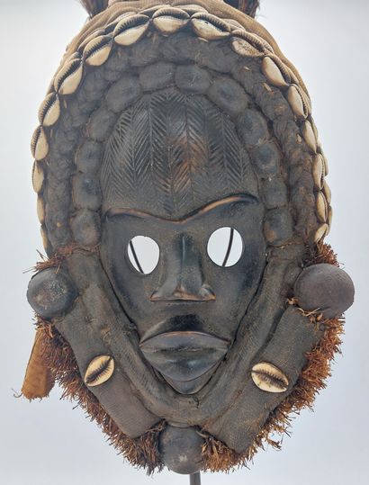 null 
DAN MASK, Ivory Coast, carved wood, fabric, feathers, cypraea, metal base,...