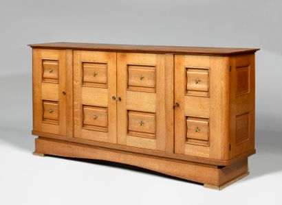  WORK OF THE 1940S Oak sideboard opening with four double-panel doors with curved...