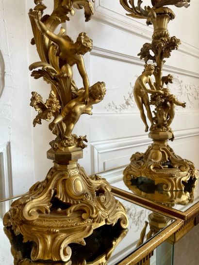 null PAIR OF CANDELABRES in gilded and chased bronze with five moving arms of lights,...