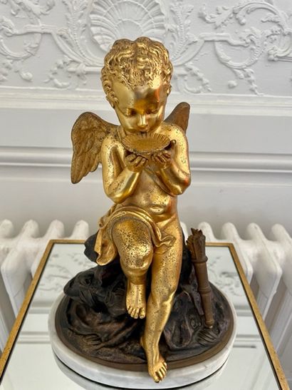 null GROUPE in gilded and patinated bronze decorated with a Love sitting on a rock...
