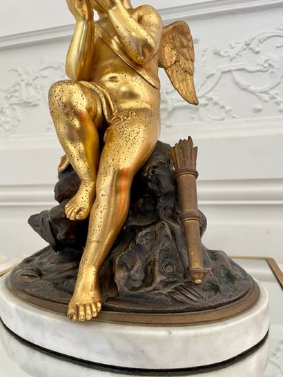 null GROUPE in gilded and patinated bronze decorated with a Love sitting on a rock...