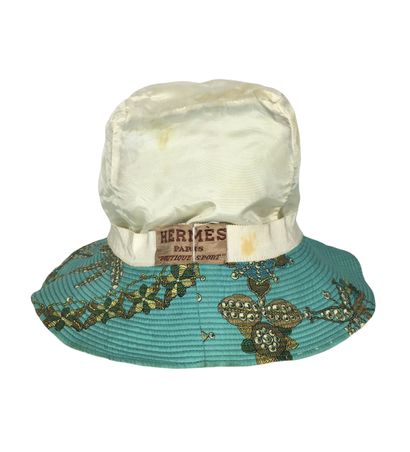 null HERMES PARIS Silk bob with gold thread and pearl motif on a turquoise blue background....