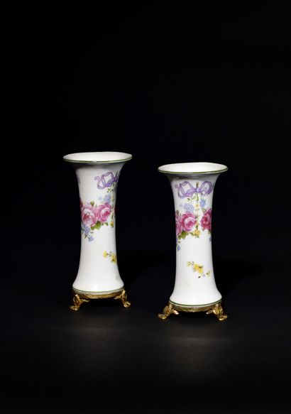 null PETITE PAIRE DE VASES CORNETS en porcelaine à fond blanc à décor de guirlandes...