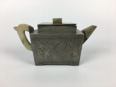 null CHINA 

Engraved pewter teapot, jade handle, grip and spout 

Late 19th century...