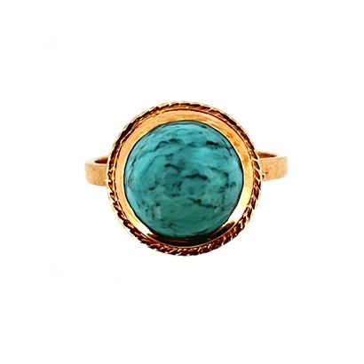 null RING 

holding a turquoise cabochon in a rope design setting. Mounted in 18K...