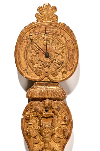 null BAROMETER IN CARVED AND GILDED WOOD,
decorated with foliage, palmette, head...