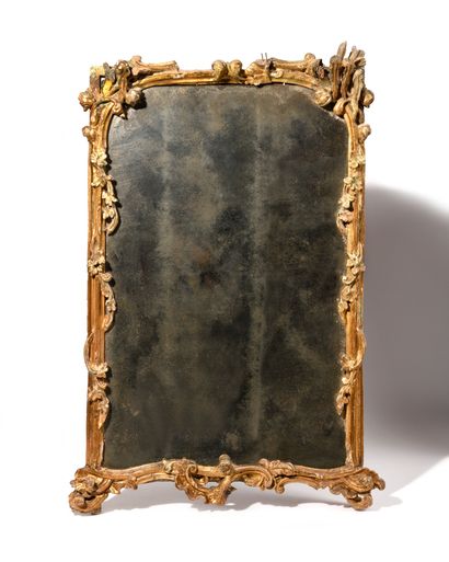 MIRROR 
in gilded and carved wood decorated...