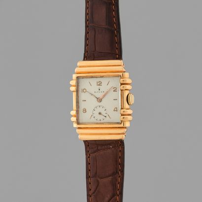 null ROLEX
Circa 1940.
Pink gold 750/1000 art deco style wristwatch, "tank" case,...