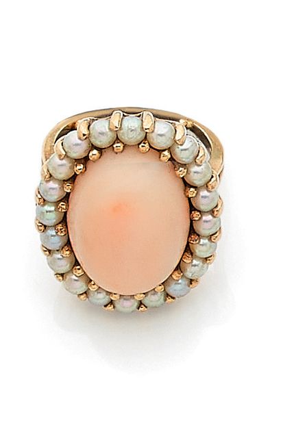null RING

holding a coral angel skin in a circle of white pearls (not tested). Mounted...