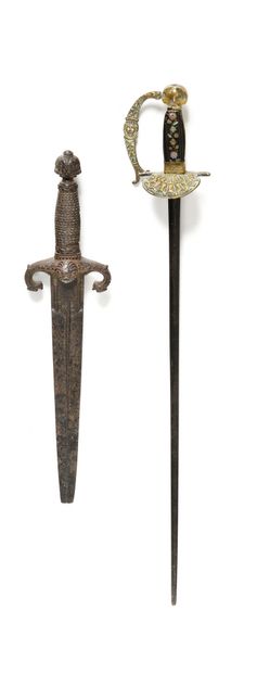 null Small dagger.

Filigreed spindle, cast iron mount chased with masks. Straight...