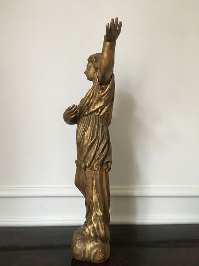 null Angel in wood carved in the round and gilded. Standing on a cloud, he is dressed...