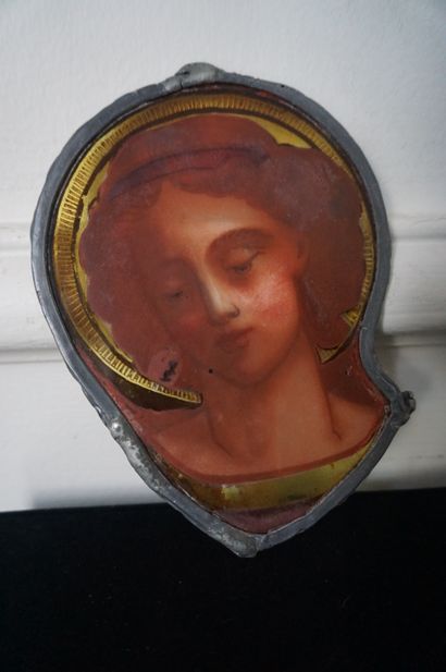 null FRAGMENT of polychrome stained glass presenting a haloed character. In a lead...