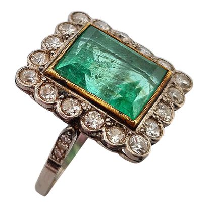 null RING 
holding a rectangular emerald of about 6 carats in a setting of old cut...