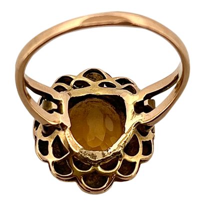 null RING 
decorated with a flower with in its center an oval citrine of approximately...