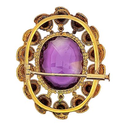 null BROCHURE
holding an oval amethyst of about 11 carats in a circular design in...