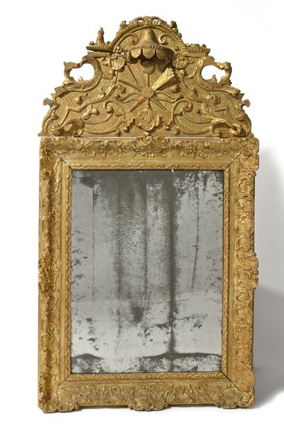 MIRROR WITH PEDIMENT IN GILDED WOOD,
decorated...