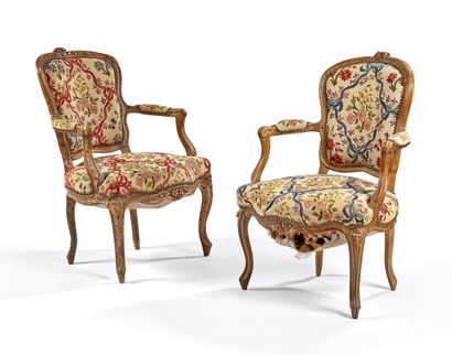 null TWO CABRIOLE CHAIRS in natural wood, molded and carved with flowers, and resting...