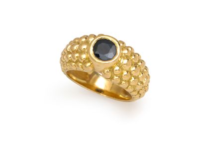null RING 
holding a round sapphire, approx. 0.75 carats, in a beaded setting. Set...