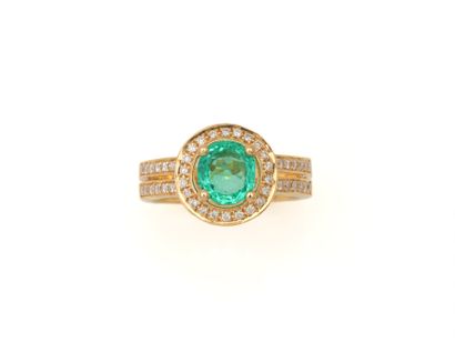 null RING 
holding an emerald weighing approximately 1 carat in a setting of round...