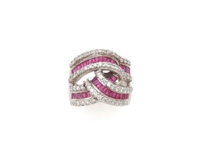null RING 
composed of an interlace with calibrated rubies set in round brilliant-cut...