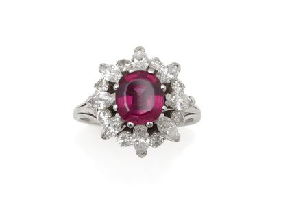 null RING 
holding an oval garnet weighing approximately 2 carats in a setting of...
