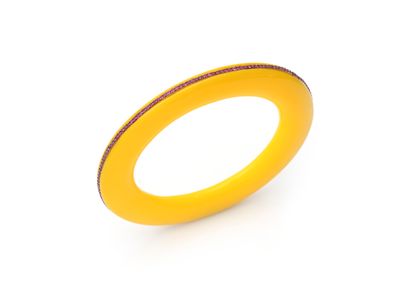 null BRACELET 
in yellow bakelite with a central line of rubies. Silver mounting....
