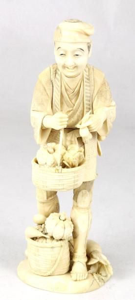 JAPON Okimono en ivoire sculpté représentant un souriant paysan à la cueillette de...