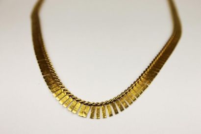 null COLLIER en or jaune souple à maille briquette lisse et ajouré. La monture en...