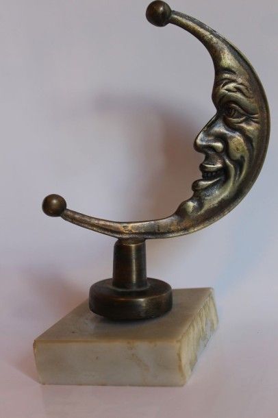 null “Lune”
Mascotte en bronze argenté. 
Montée sur socle en marbre. 
H: 13.5 cm...
