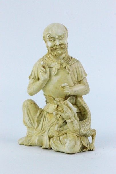 null CHINE Statuette en ivoire représentant un moine Bouddhiste avec un dragon. Marque...