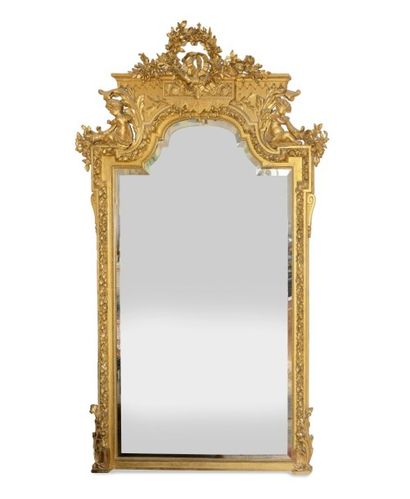 null Grand MIROIR en bois doré, mouluré et sculpté d' une guirlande de fleurs, le...