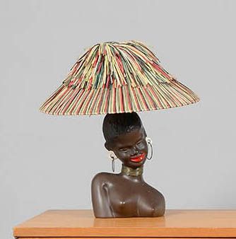  TRAVAIL DES ANNEES 1950 « L’Africaine souriante » Lampe en céramique émaillée brun,...