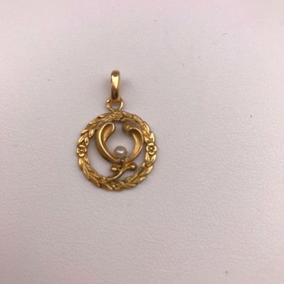 null A yellow gold and natural pearl pendant.