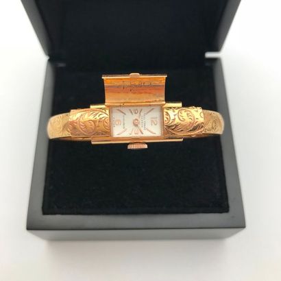 null A yellow gold lady's wristwatch by Paul Franz Genève
Bracelet jonc ouvrant également...