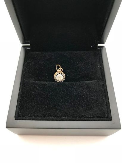 null A yellow gold and diamond pendant.