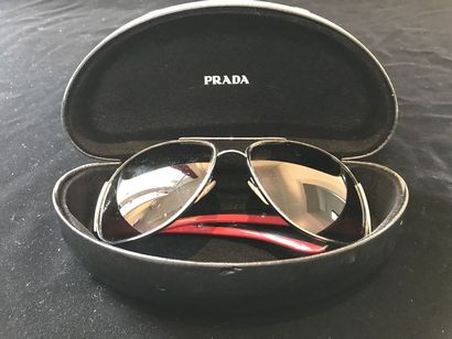 null PRADA - ROLEX Deux paires de lunettes de soleil accompagnées de leurs etuis....