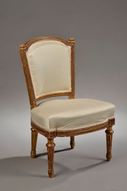 null Low chair with cabriolet backrest in moulded and gilded wood (splinters). The...