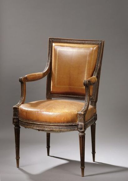 null Armchair with a slightly curved trapezoidal backrest in beech wood densely carved...