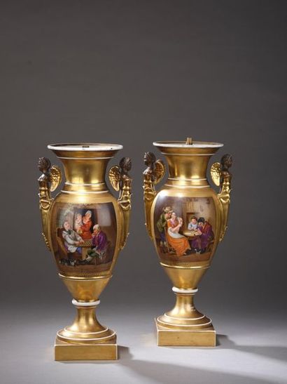 null PARIS. Pair of porcelain baluster vases with gold bottom, the holds in winged...
