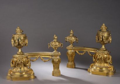 null Pair of chased and gilded bronze fires. A large oak-leaf garlanded stewpot rests...