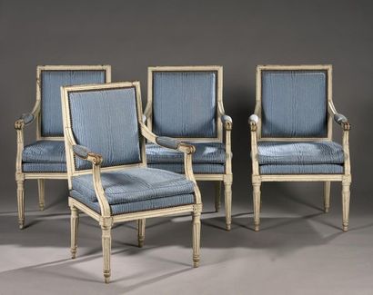 A suite of four armchairs with square molded...