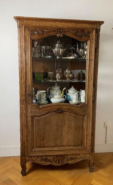 null Oak display cabinet and its contents of silver plated metal and porcelain glassware...