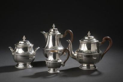 null A silver tea and coffee service in the form of a fluted baluster, underlined...