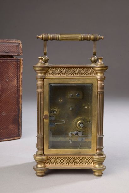 null Traveling clock with four fluted columns, beveled glass panels with brass plates...