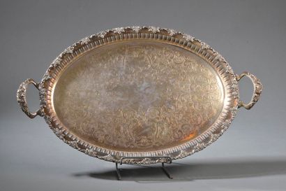 null Oval silver-plated copper tray, the basin engraved with volutes of foliage,...
