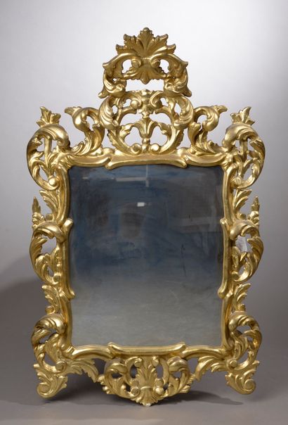 null Mirror in linden and carved and gilded composition openworked with palmettes...