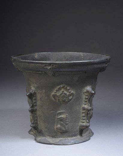 null Bronze mortar with four buttresses and applied patterns of man profiles and...