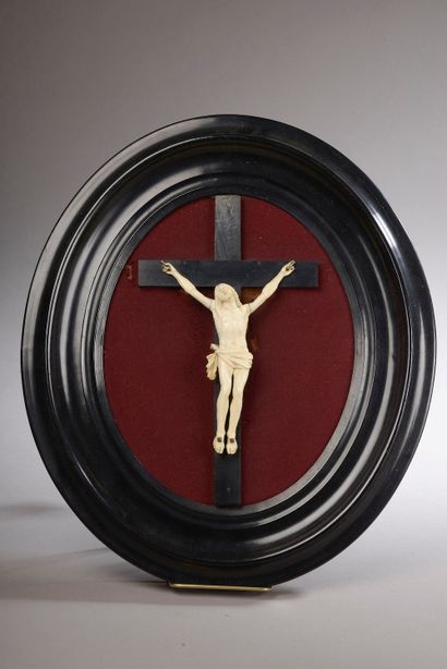 null Crucifix in ivory (elephantidae spp) in an oval blackened wooden frame (one...